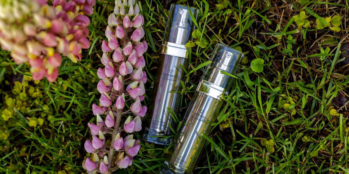 Ddifference 5D Cell Innovation anti aging creams on a grass with purple lupine plant