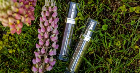 Ddifference 5D Cell Innovation anti aging creams on a grass with purple lupine plant