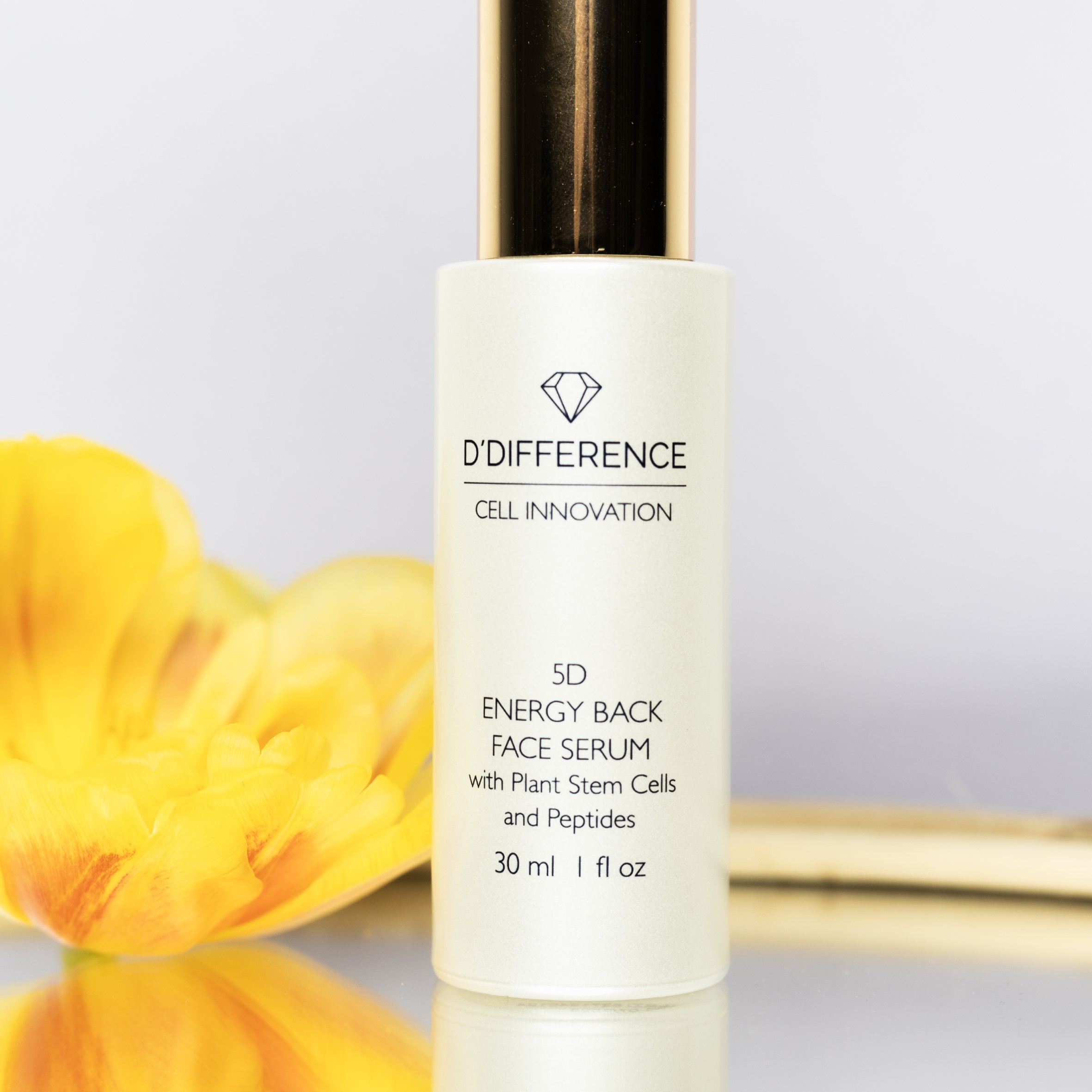 D'DIFFERENCE Cell Innocation 5D Energy Back Serum with Plant Stem Cells and Peptides pump bottle with a background of a yellow flower.