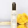 Photo of D'DIFFERENCE Cell Innovation 5D power Back Face oil with Rosehip oil and Anti-Ageing Actives on a background with a yellow flower