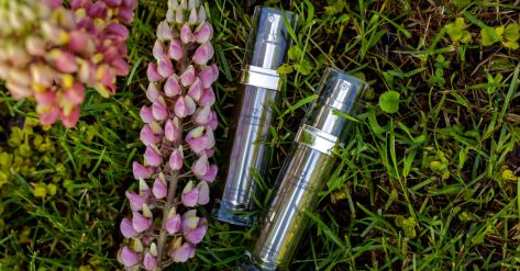 Ddifference 5D Cell Innovation anti aging creams on a grass with purple lupine plant